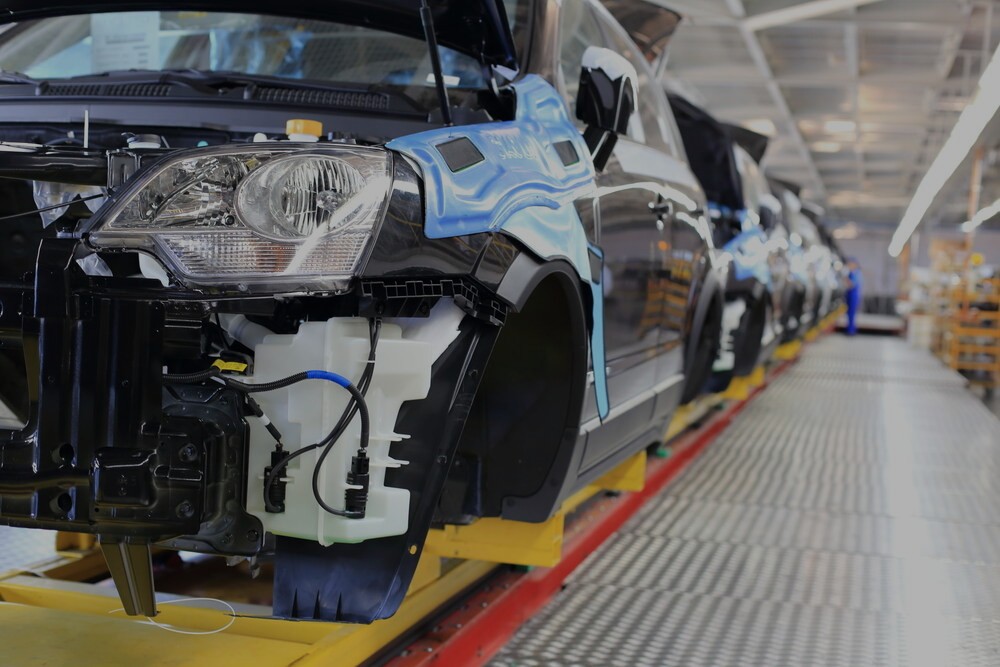 Cars being assembled in car factory dark