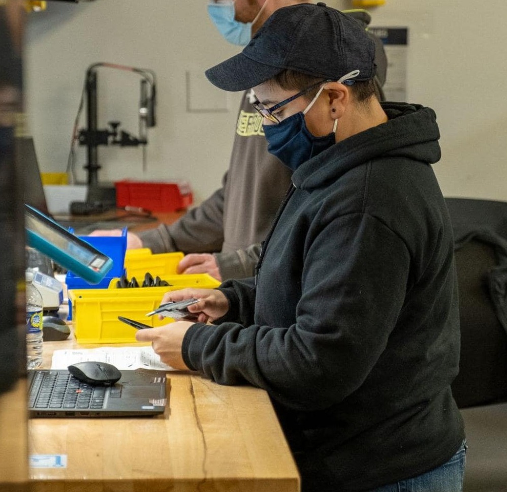 Engineer in a black hoodie and cap